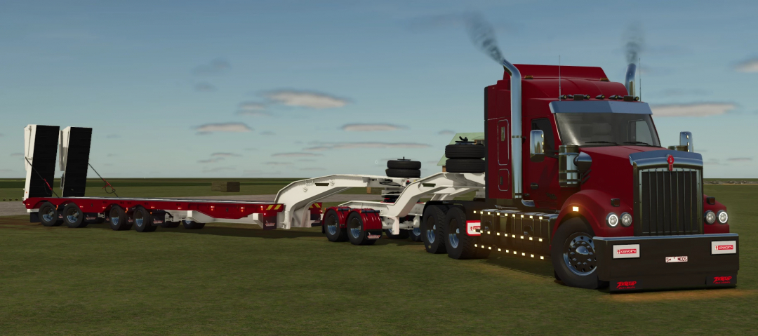 FS25 mod Drake Active Steer Quad trailer with red Kenworth truck on a grassy field.