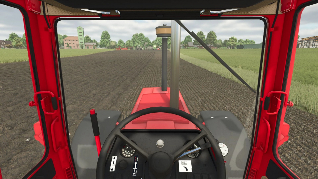 View from inside the IHC 1255-1455 XL tractor mod in Farming Simulator 25, showing a field being plowed.