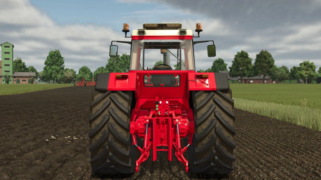 Rear view of IHC 1255-1455 XL mod in Farming Simulator 25, showcasing large tractor wheels on a farm field. FS25 mods.