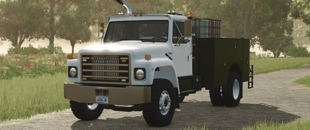 International S1800 Service Truck mod in FS25, parked on a road surrounded by trees.