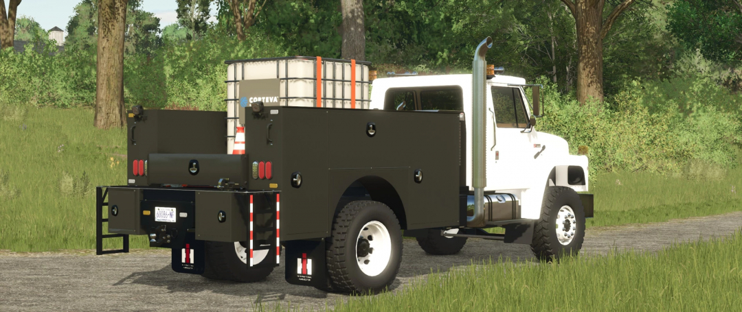 International S1800 Service Truck mod in FS25, parked on a rural road with greenery.