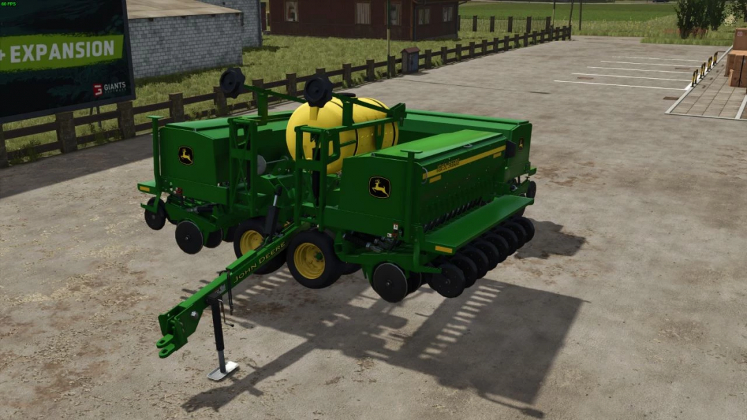 John Deere 455 Box Drill mod for Farming Simulator 25 parked on a paved area.