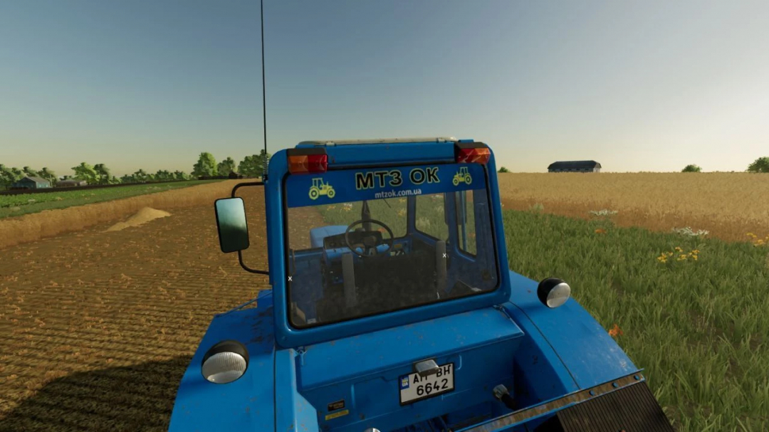 FS22 mod MTZ TOP UA v1.0.0.0 showing rear view of a blue tractor on a farm field