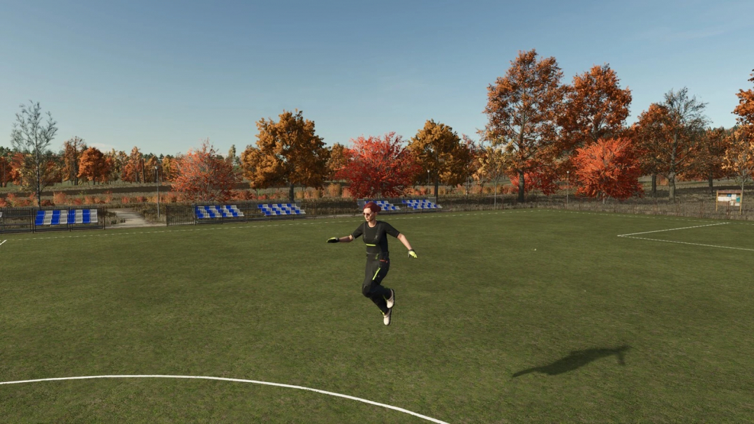 FS25 mod Nimble Jumping v1.0.0.0 shows player mid-air with autumn trees and seats on a sports field.