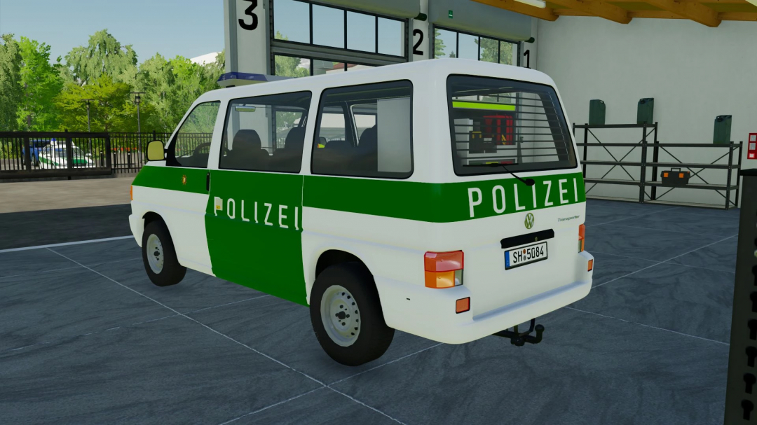 VW T4 Polizei SH Livery mod in FS22, showcasing a green and white police van parked indoors.