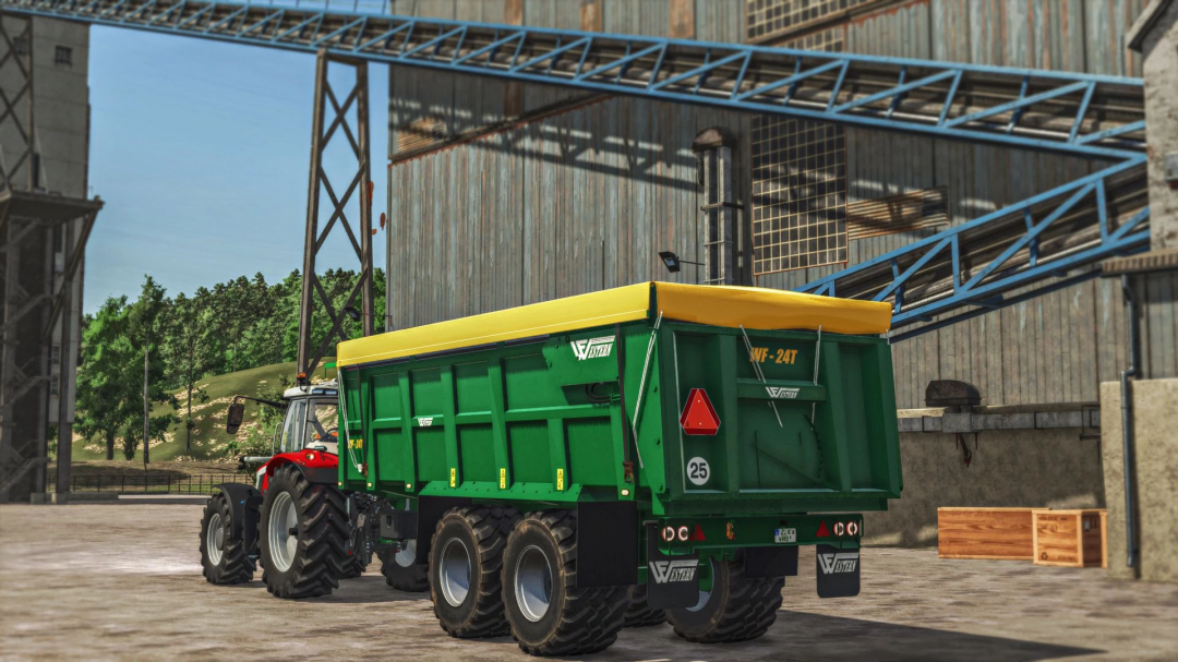 FS25 mod Western Fabrications 24T v1.0.0.0 green trailer attached to a red tractor in an industrial setting.