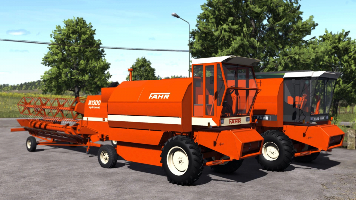 fs25-mods, Two orange Fahr combine harvesters displayed on a paved area in Farming Simulator 25. FS25 mods showcase.