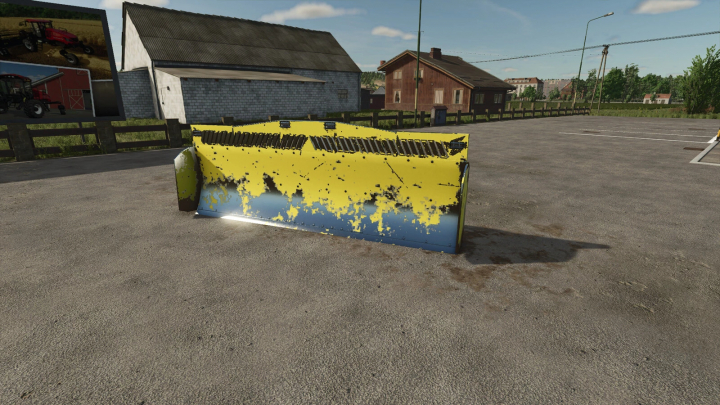 fs25-mods, K700 Sliding Shield mod in Farming Simulator 25, version 1.0.0.0, shown in a parking area with surrounding buildings.