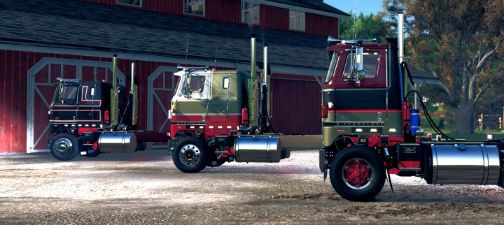 fs25-mods,  Three Transtar trucks in different colors parked beside a barn in FS25 mod Transtar Edit v1.0.0.0.