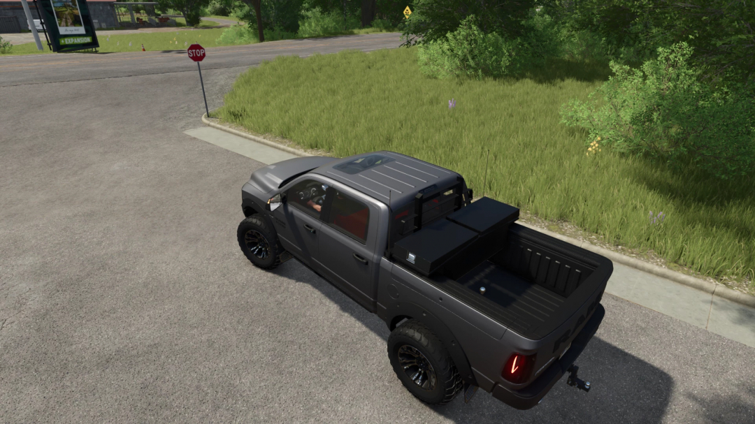 Gray 2016 Dodge Ram Rebel 1500 mod in FS25, showcased near a grassy road intersection.