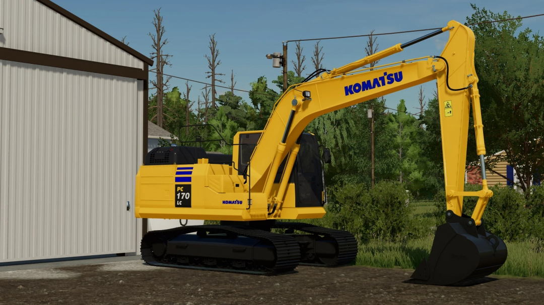 FS22 Komatsu PC170LC-11 excavator mod in Farming Simulator 22, shown next to a building with trees in the background.