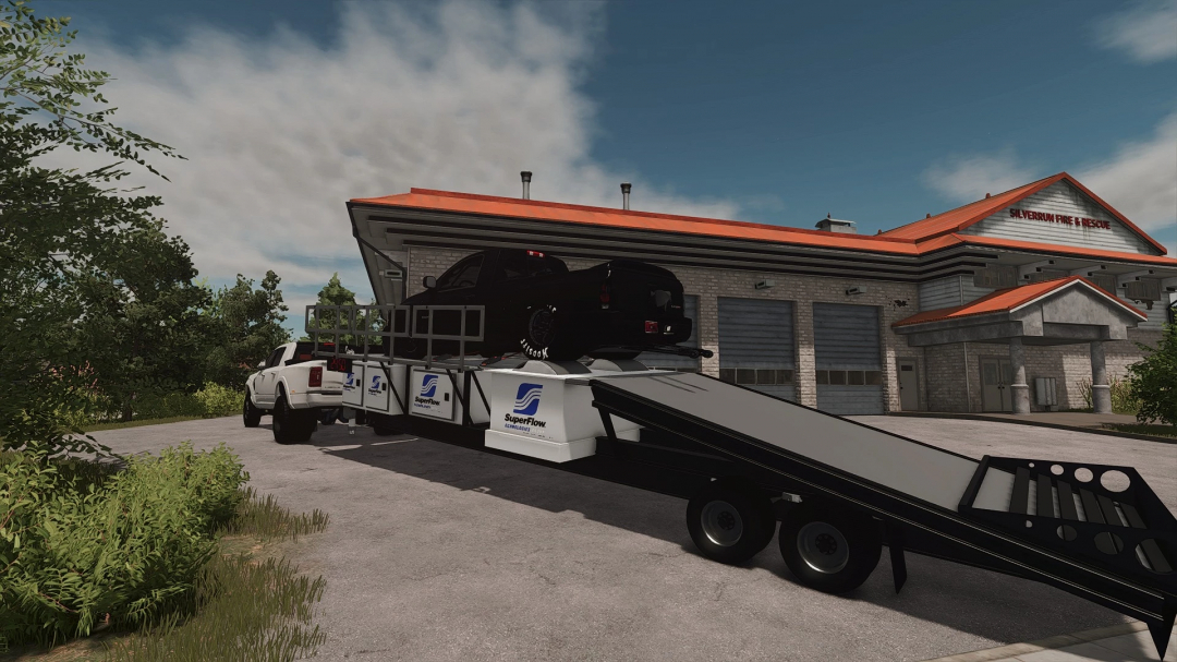 FS25 SuperFlow Dyno Trailer mod showcasing a car on the trailer outside a firehouse in Farming Simulator 25.