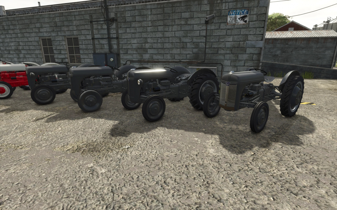 Vintage Ford N series tractors in FS25 mod parked on concrete.