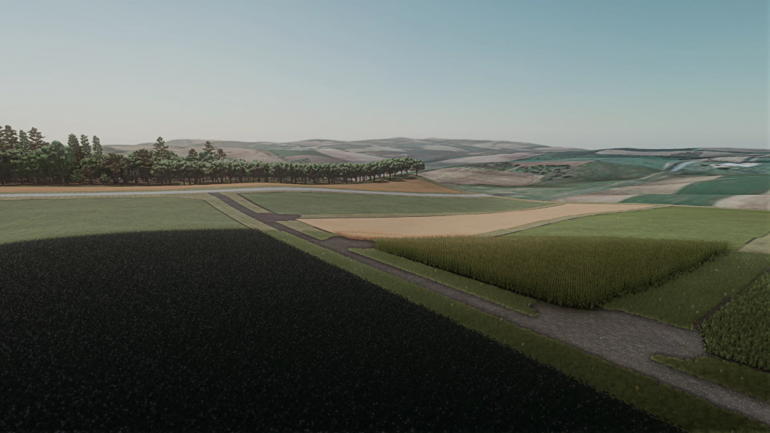 FS25 mod Forest Wisconsin v1.0.0.0 features vast farmland with fields, trees, and a road in a scenic landscape.