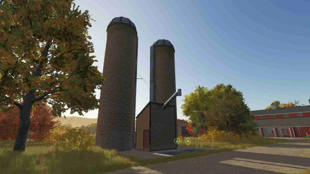 Grass Fermentation Silage Silo mod in FS25, featuring twin silos surrounded by autumn trees and farm buildings.