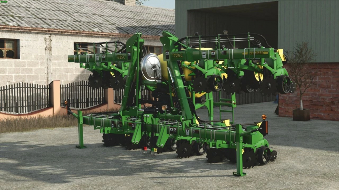 John Deere 1725C Seeder mod for FS25 displayed in a yard, showcasing its detailed design and green color.