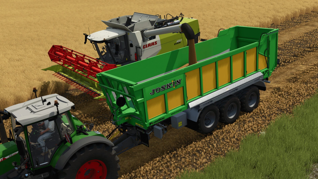 FS25 mod Joskin Cargo v1.0.0.0 in a field during harvest, showcasing a green and yellow trailer attached to a tractor.