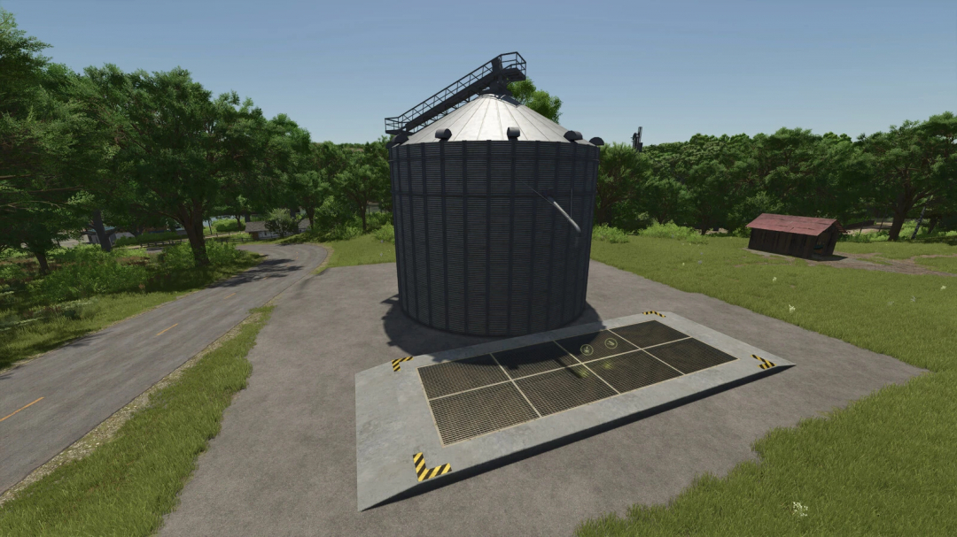 FS25 mod Lizard Silos v1.0.0.0 showing a large storage silo in a rural setting with trees and a road.