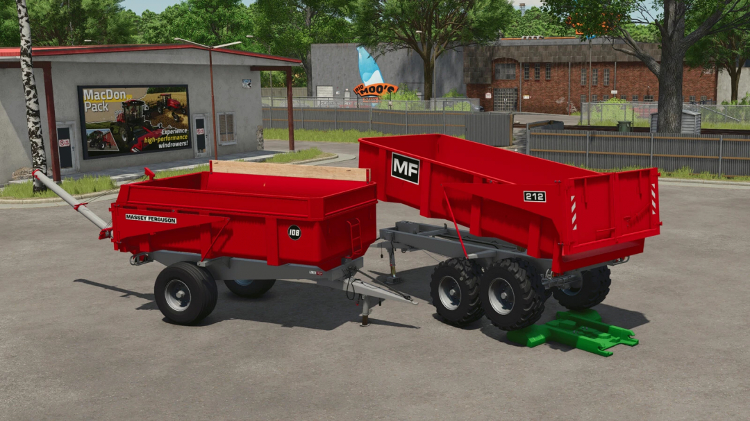 Massey Ferguson Trailer Pack in FS25, featuring two red trailers parked outside a building.