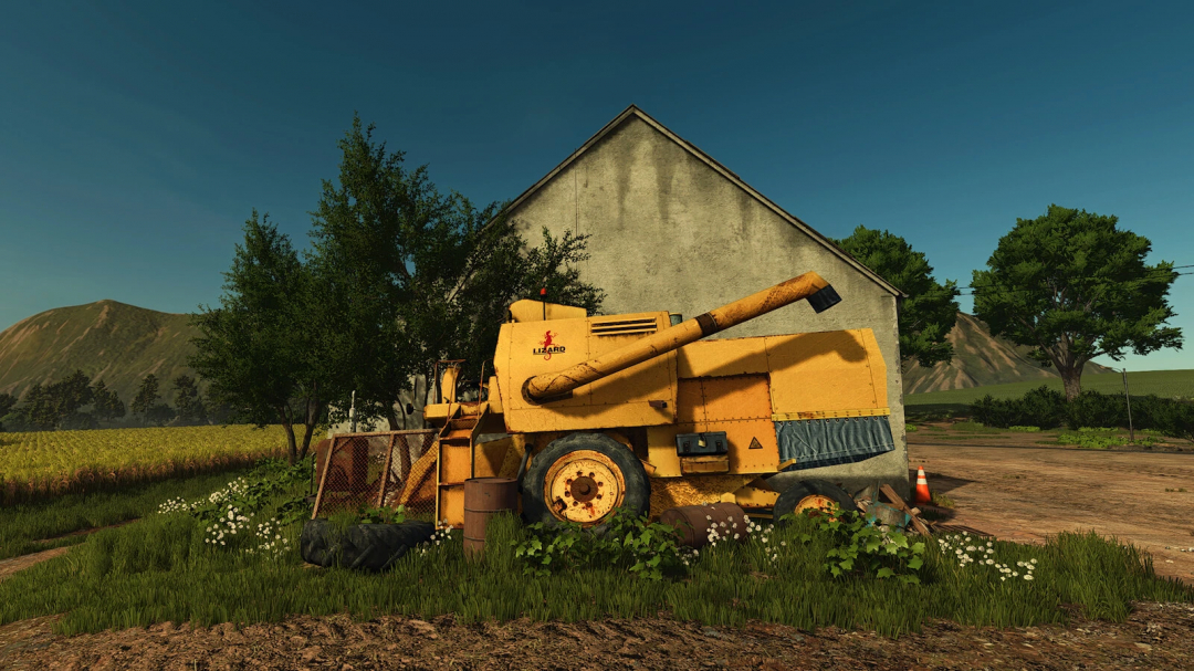 Old yellow farming machine next to a barn in FS25 mod Scrap For The Farm v1.0.0.0.