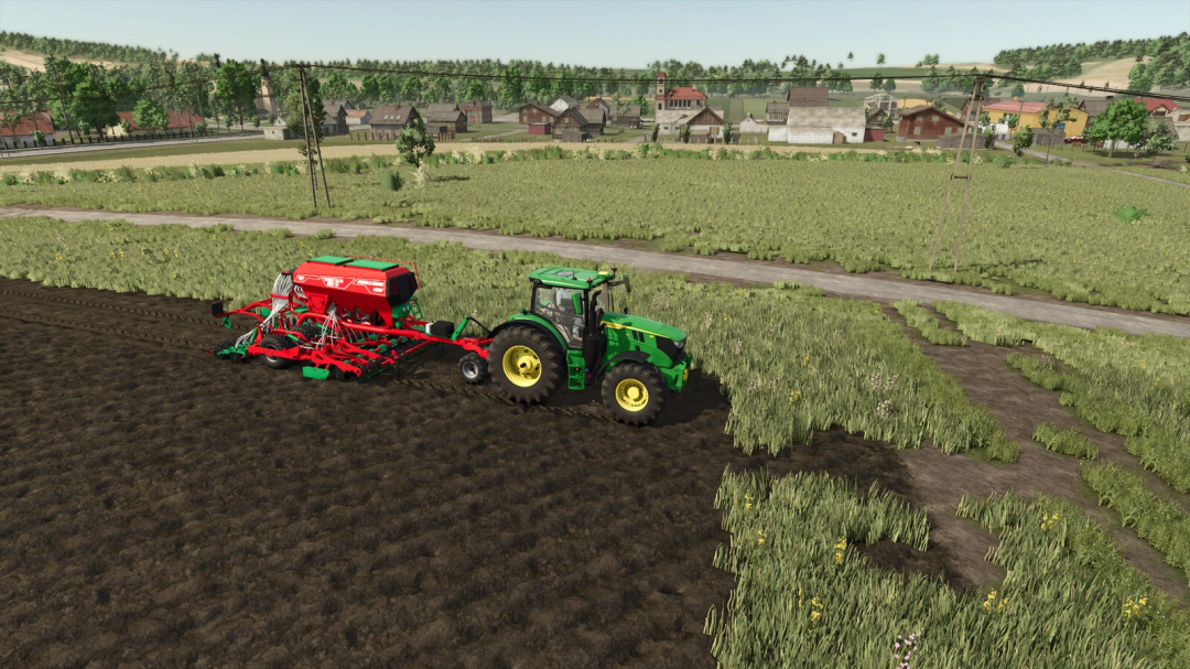 FS25 Seeds Addon mod: Tractor with seed drill working on a field near a village.