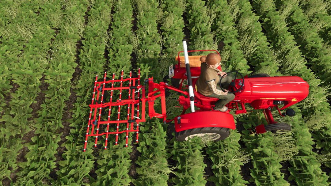 A farmer operates a red tractor with a weeder attachment in FS25 mods, demonstrating precision farming in Farming Simulator 25.