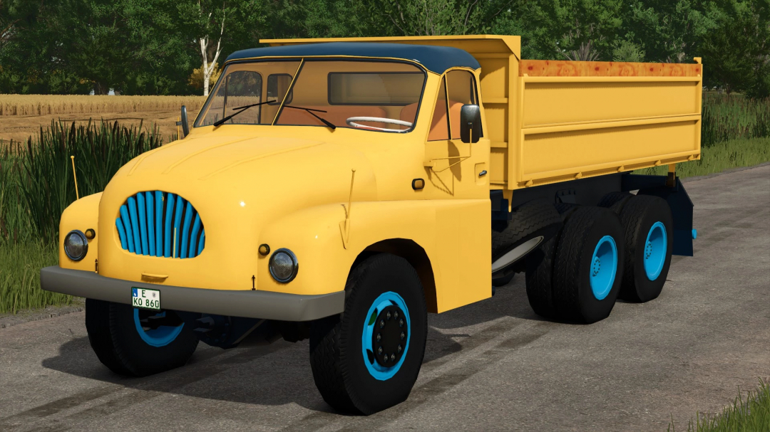 Yellow Tatra T 138 truck mod in FS25 with blue wheel rims, parked on a rural road.