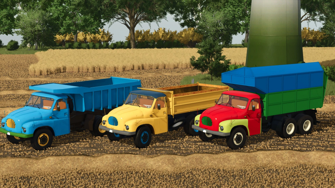 Three colorful Tatra T 138 trucks with trailers in a farm field, featured in FS25 mods.