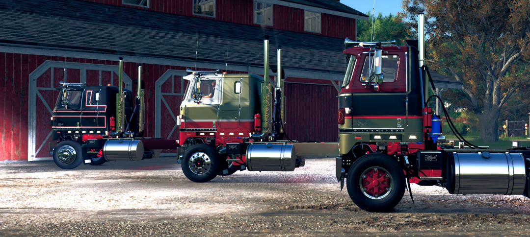 Three Transtar trucks in different colors parked beside a barn in FS25 mod Transtar Edit v1.0.0.0.