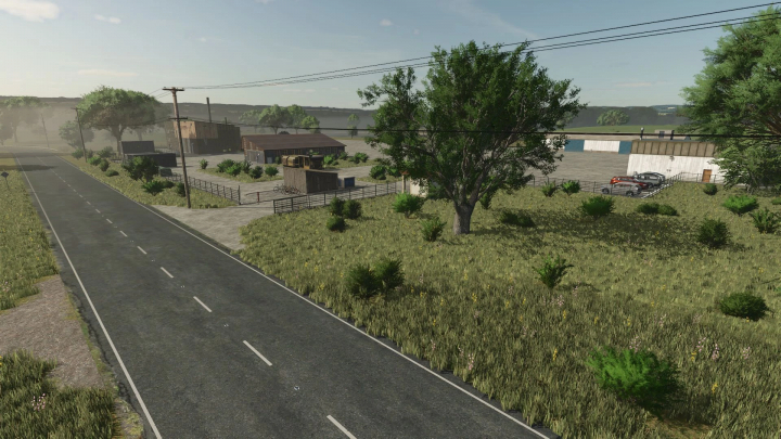 fs25-mods,  Rural scene from Drakurza Map mod in FS25 featuring road, buildings, and grassland.