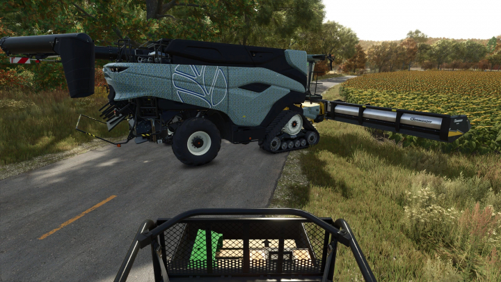 fs25-mods, FS25 mods: Harvesting machine with a modern design in Farming Simulator 25, featuring the Toolbox v1.0.0.0 mod, beside a sunflower field.