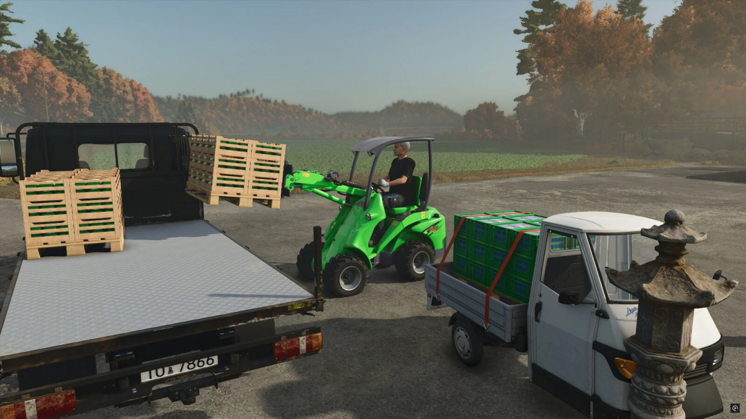 A player uses the AVANT-Series loader in Farming Simulator 25 to transport crates onto a truck. FS25 mods enhance gameplay.