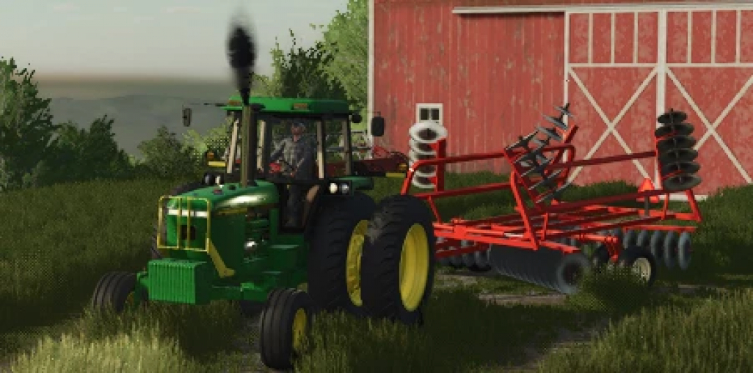 FS25 Allis Chalmers 2500 Disk mod in use, attached to a green tractor near a red barn, illustrating Farming Simulator 25 gameplay.