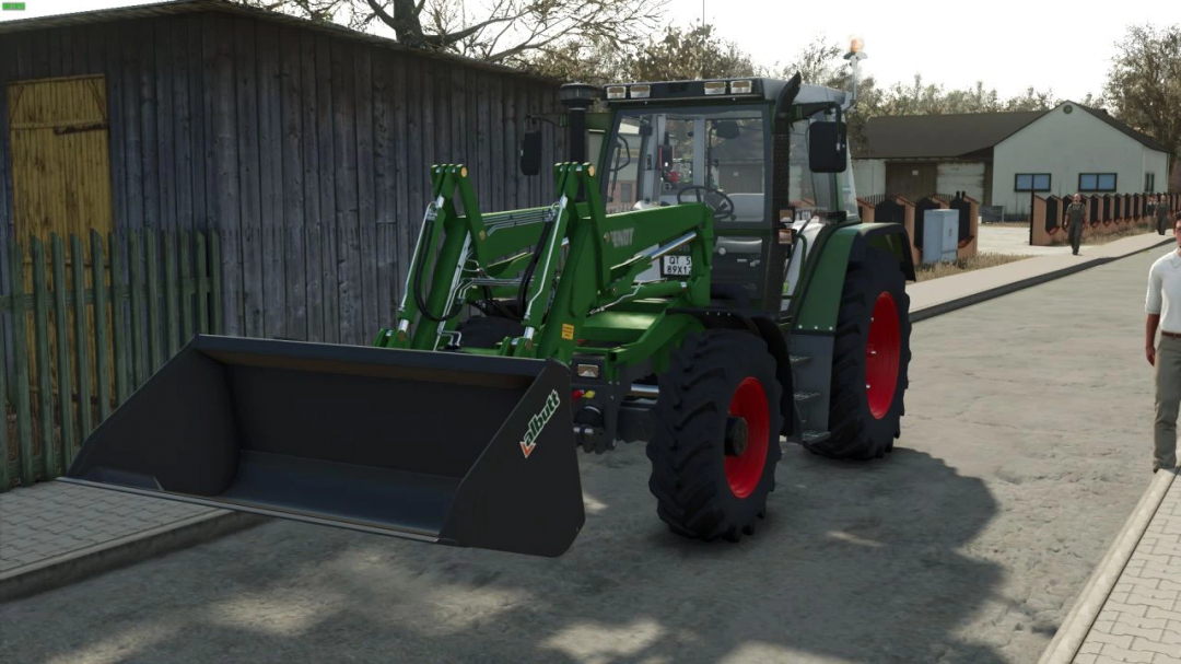 Fendt 380 GTA Pack FS25 mod showing a tractor with a front loader parked on a street.