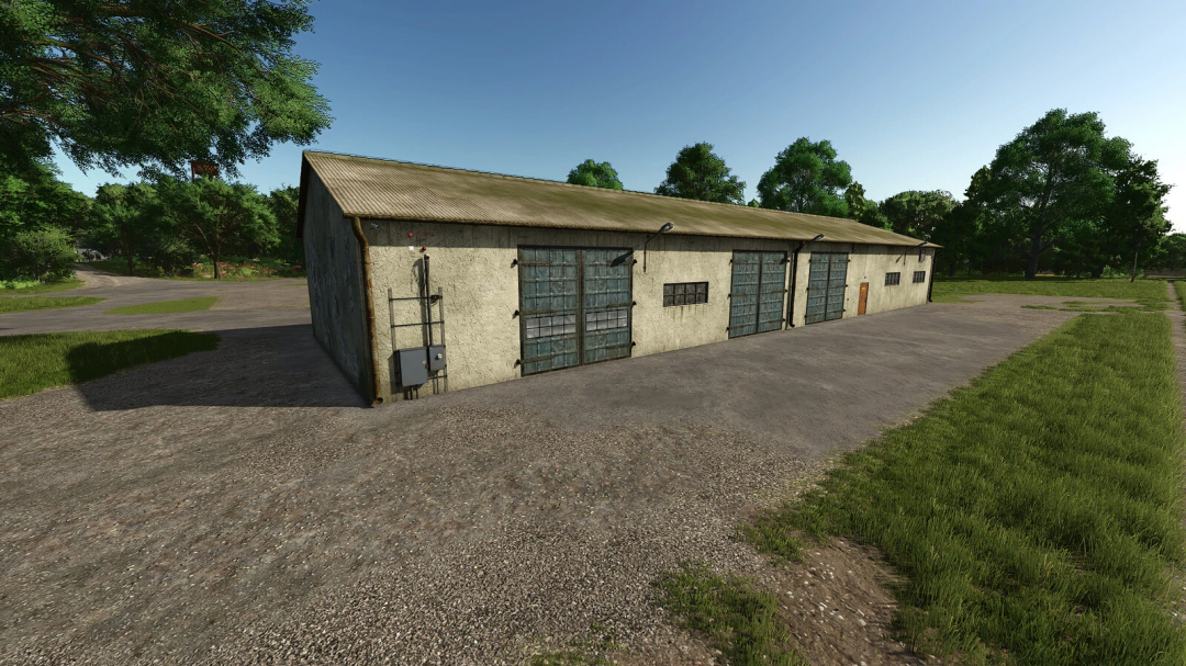 FS25 mod Garage With Workshop v1.0.0.0 featuring a large concrete building with multiple garage doors and surrounding trees.