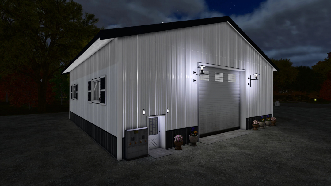 Night view of Garage With Workshop mod for FS25, showing illuminated exterior with garage door and potted plants.