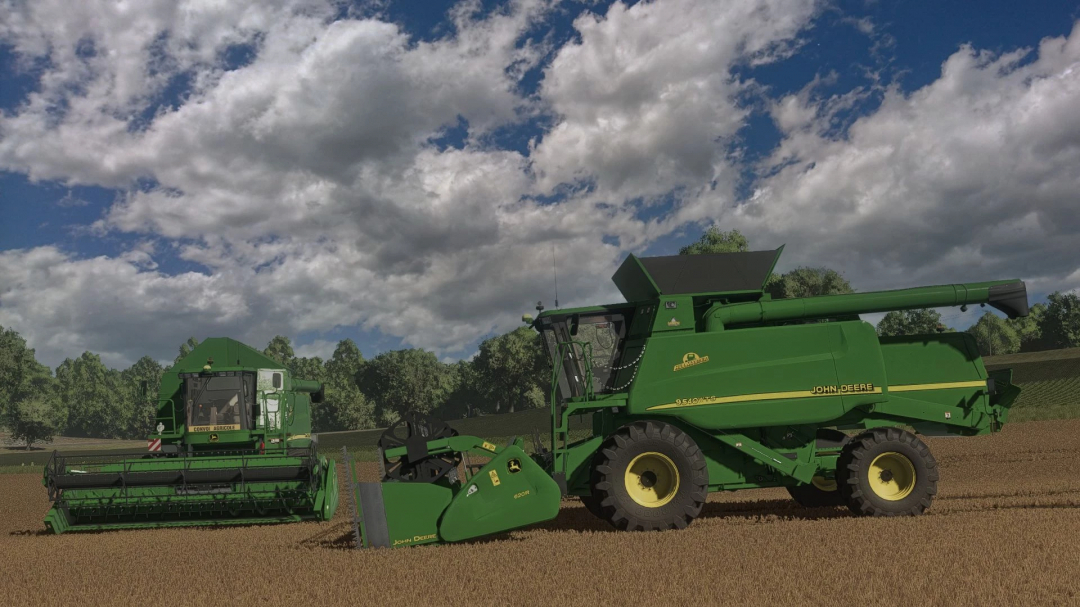 Two John Deere harvesters in a field under a cloudy sky in FS25 mods.