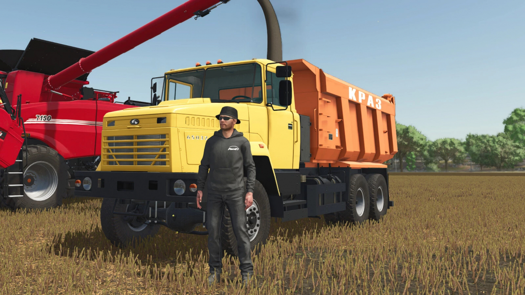 Kraz 65032 truck mod in Farming Simulator 25 with a person standing in front, next to a red harvester.