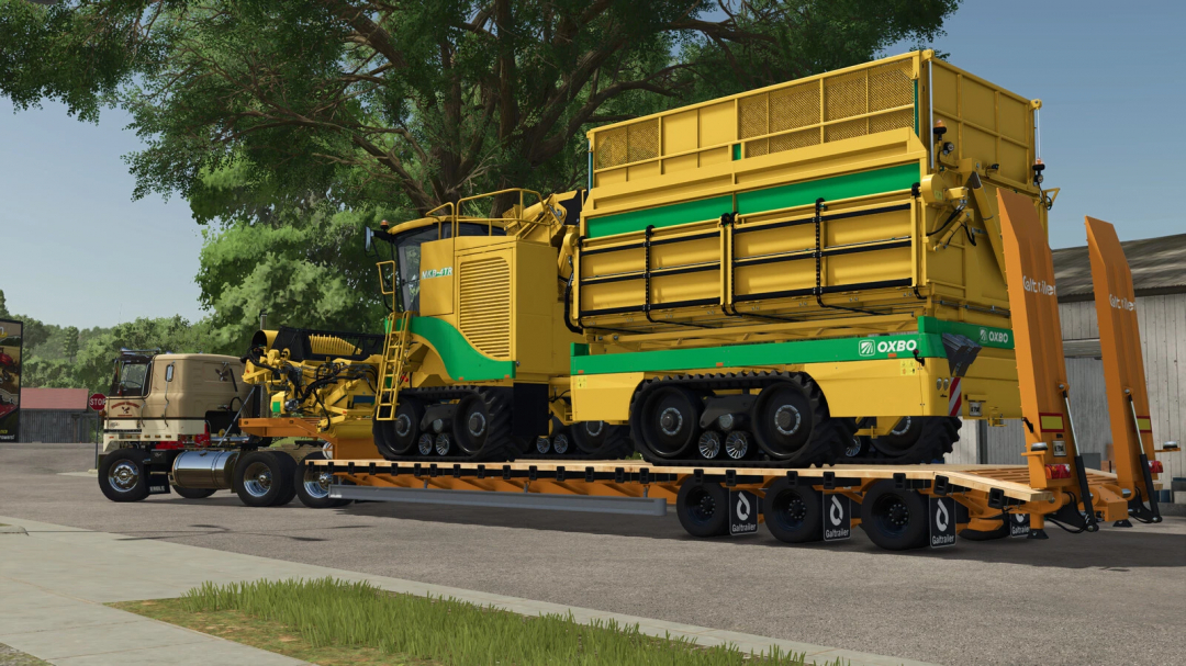 Low Loader Galtrailer v1.0.0.0 mod in FS25 transporting a large yellow-green agricultural machine.