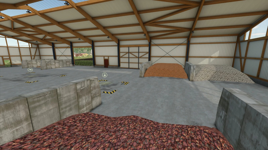 Interior of a large warehouse from FS25 mods with piles of different materials on the floor.