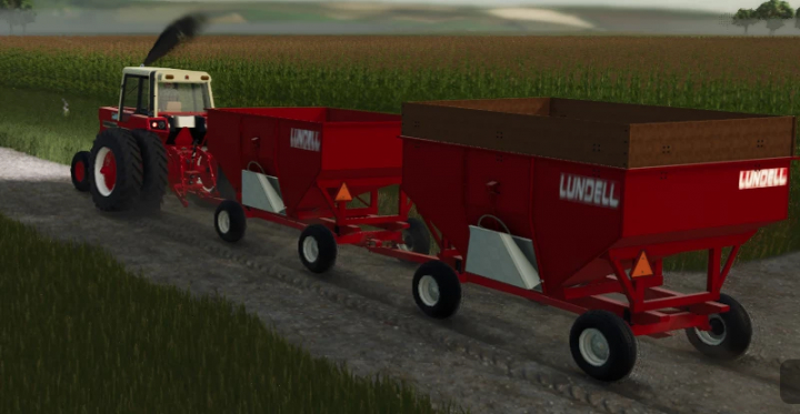 fs25-mods, FS25 mod: Lundell Gravity Wagons being towed by a red tractor on a dirt path, showcasing Farming Simulator 25 mods.