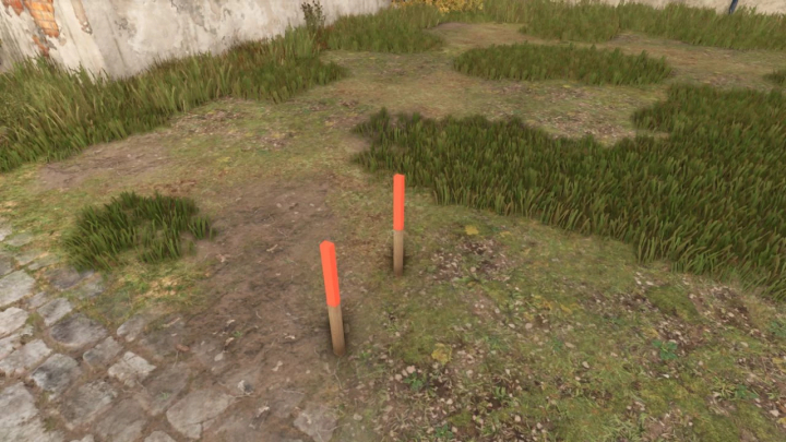 fs25-mods, Site stake mod in Farming Simulator 25 with two wooden stakes and orange tips on grassy terrain.