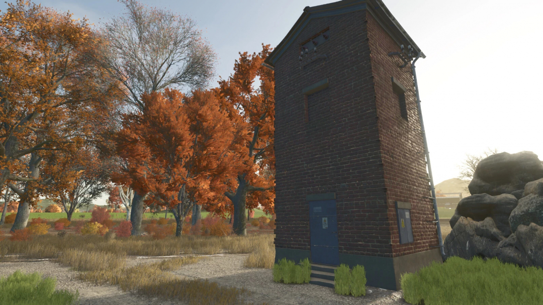 A solar generator mod in FS25, featuring a brick structure amid autumn trees.
