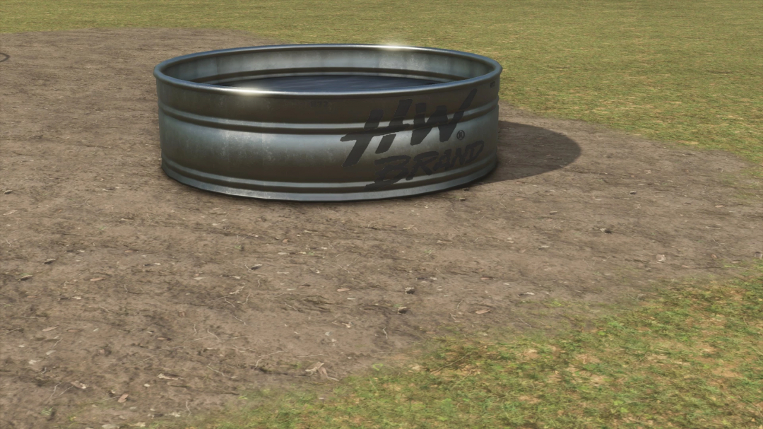 Farming Simulator 25 mod: TSX Open Pastures v1.0.0.0, a metal feed trough on a dirt field with grass in the background.