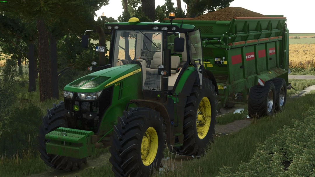 FS25 John Deere 7R 2014 mod showcasing tractor pulling a green trailer in a rural setting.