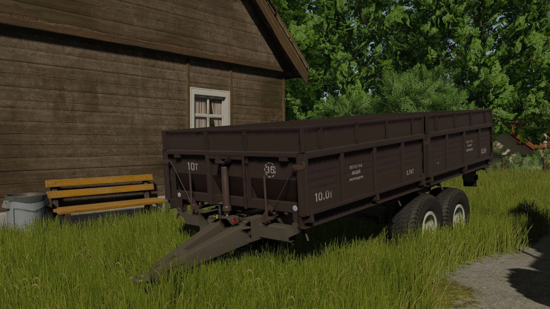 Farming Simulator 25 mod: Fliegl VFW 10600 trailer next to a barn with green grass and trees.