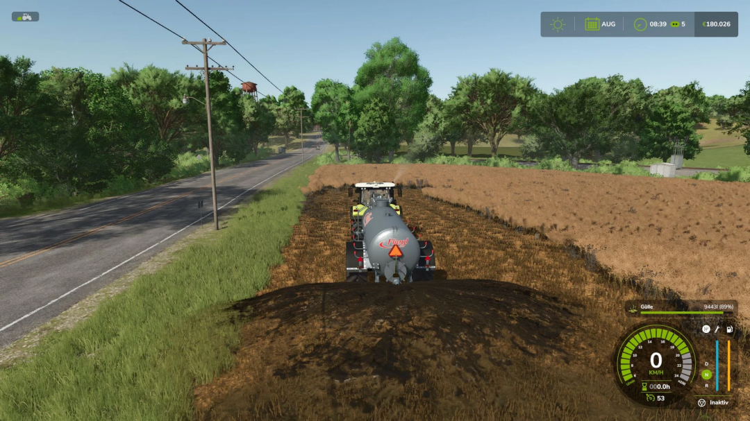 Farming Simulator 25 mod: Fliegl VFW 10600 tank spreading manure on farm field close to a road in FS25.