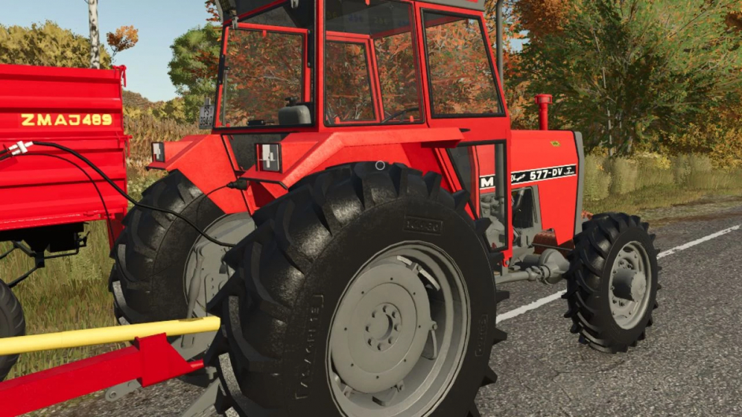 Farming Simulator 25 mods: Red IMT 577-DV tractor with large tires, parked on the roadside, showcasing a detailed agricultural mod.