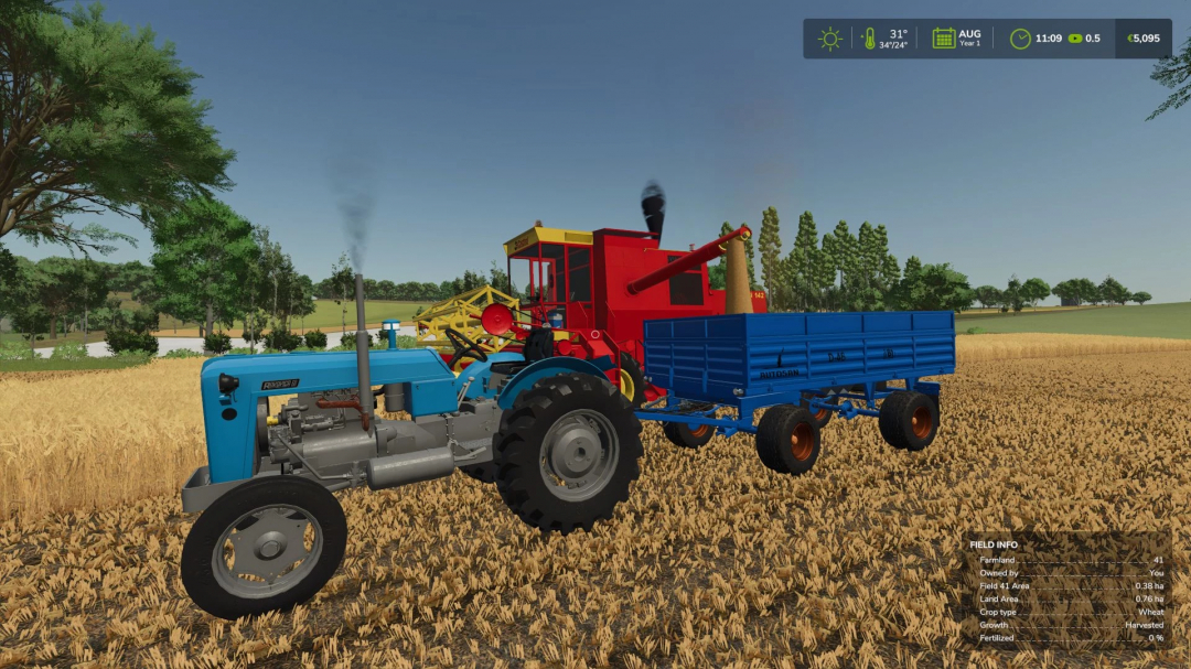 Farming Simulator 25 mod: Classic blue tractor with attached blue trailer working on a wheat field during sunny weather.