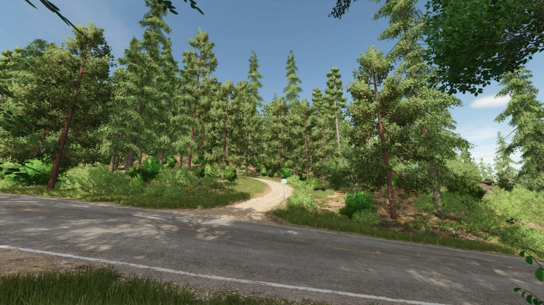 Scenic view of a dirt road winding through a lush forest in Farming Simulator 25 with the Riverbend Springs Forest mod.